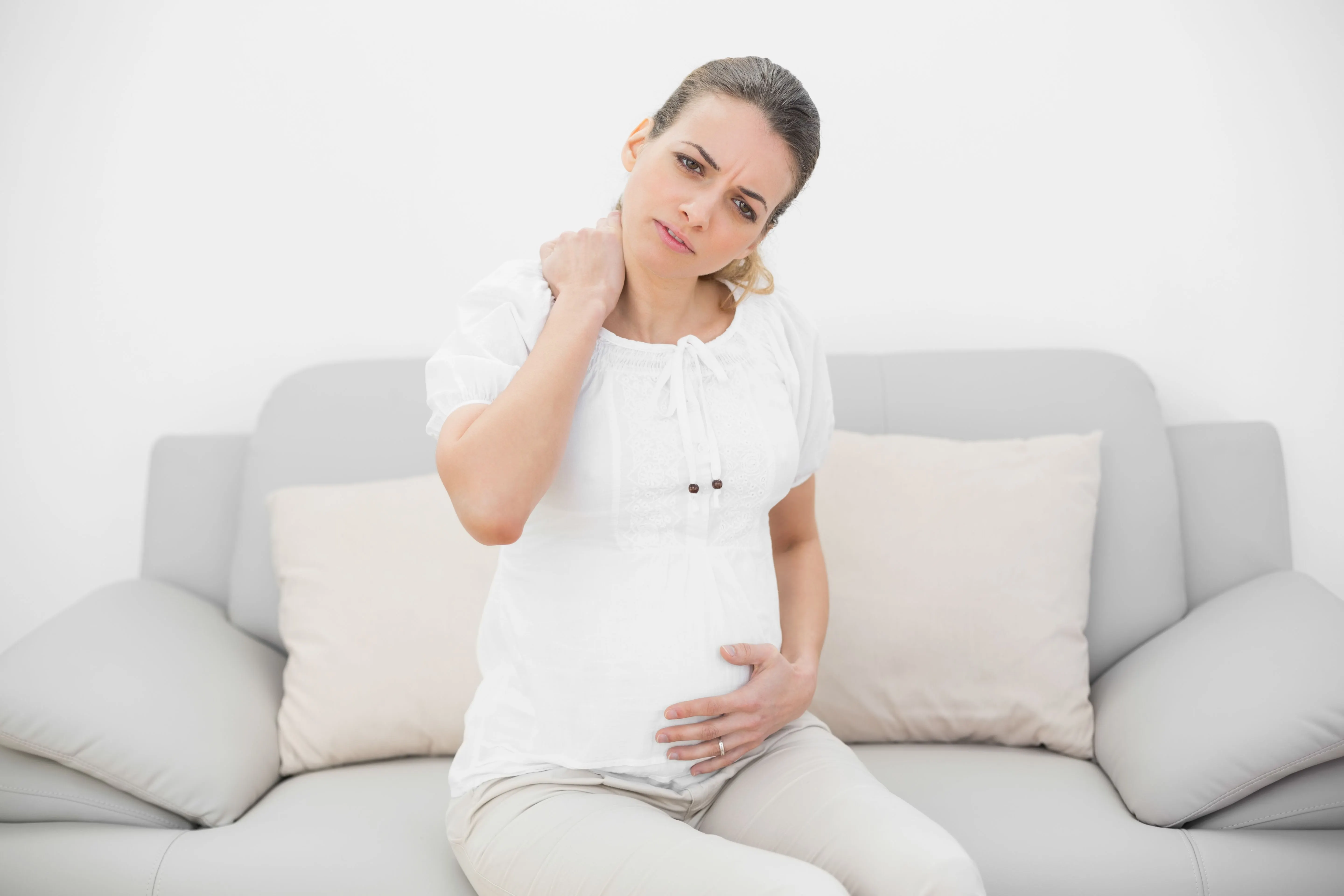 New mother considering postpartum recovery care at Roots Chiropractic and Wellness