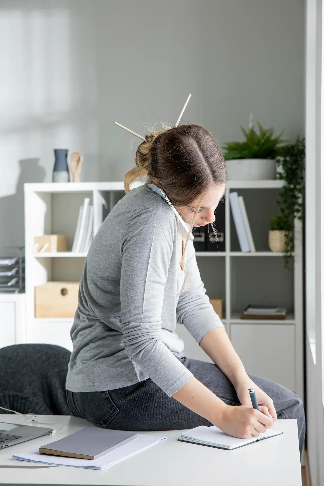 Person concerned about posture problems at Roots Chiropractic and Wellness Alma